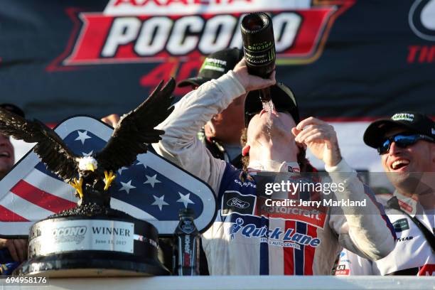 Ryan Blaney, driver of the Motorcraft/Quick Lane Tire & Auto Center Ford, celebrates in Victory Lane after winning the Monster Energy NASCAR Cup...