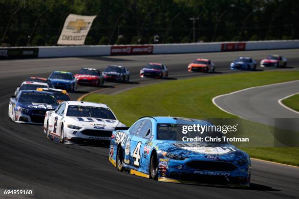 Kevin Harvick, driver of the Busch Beer Ford, leads a pack of cars during the Monster Energy NASCAR Cup Series Axalta presents the Pocono 400 at...