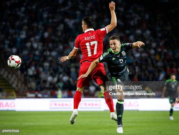 James Chester of Wales competes for the ball against Filip Kostic of Serbia during the FIFA 2018 World Cup Qualifier between Serbia and Wales at...