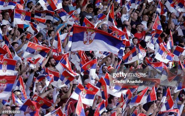 Serbian national team supporters wave flags during the FIFA 2018 World Cup Qualifier between Serbia and Wales at stadium Rajko Mitic on June 11, 2017...