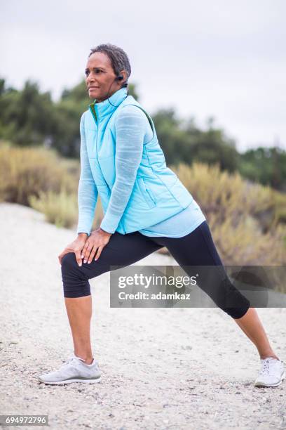 senior black woman stretching - female muscle calves stock pictures, royalty-free photos & images