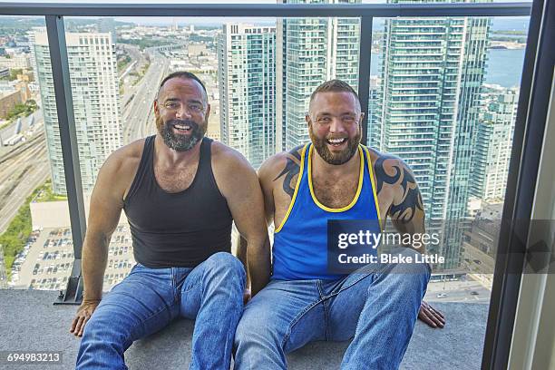 male couple on balcony city view portrait - impersonator stock pictures, royalty-free photos & images