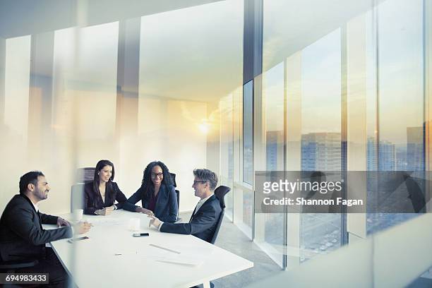 business colleagues talking in meeting room - réunion d'affaires photos et images de collection
