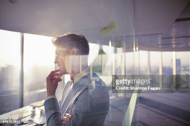 man standing with ideas in planning office room - reflection glass stock pictures, royalty-free photos & images