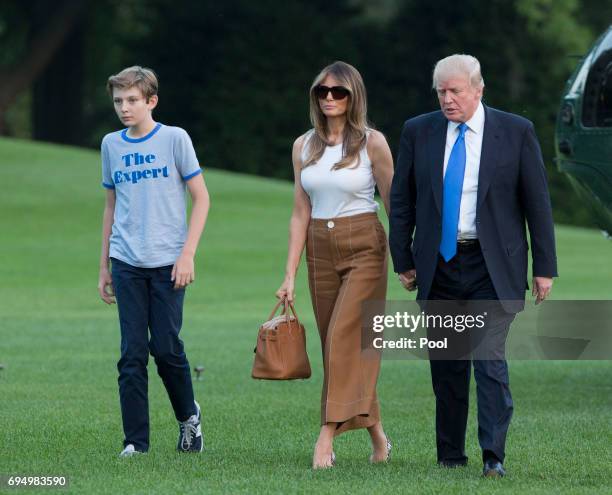 President Donald Trump, first lady Melania Trump and their son Barron Trump arrive at the White House June 11, 2017 in Washington, DC. According to...