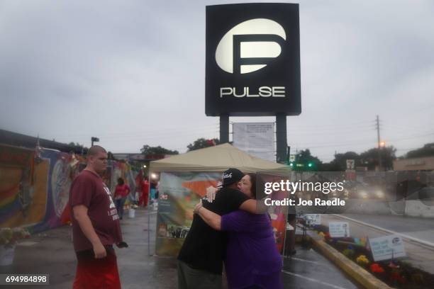 Neema Bahrami and Jacque Azevrdo hug outside the Pulse gay nightclub one day before the one year anniversary of the shooting on June 11, 2017 in...