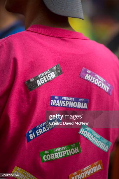 Man wears a variety of resist stickers at the #ResistMarch during the 47th annual LA Pride Festival on June 11 in the Hollywood section of Los...