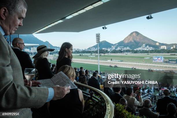 Exclusive members of the Jockey Club hippodrome watch the horses go to the starting position for the Grande Premio Brasil, Brazil's biggest horse...