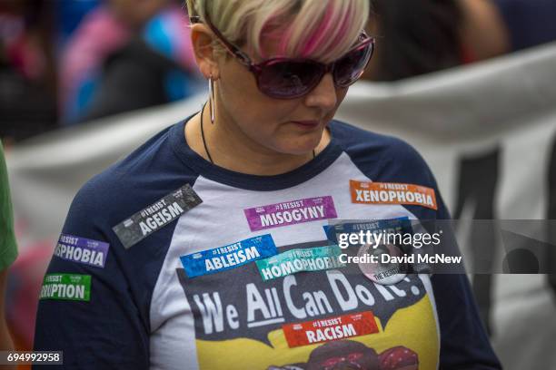 Woman wears a variety of resist stickers at the #ResistMarch during the 47th annual LA Pride Festival on June 11 in the Hollywood section of Los...