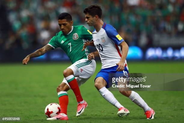 Javier Aquino of Mexico fights for the ball with Christian Pulisic of US during the match between Mexico and The United States as part of the FIFA...
