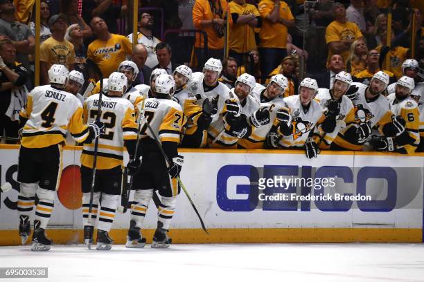 Patric Hornqvist of the Pittsburgh Penguins high fives teammates after scoring a goal against the Nashville Predators during the third period in Game...