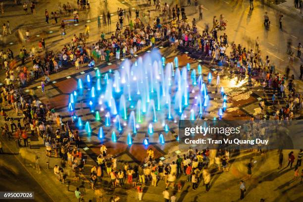 people are surrounded by music performances at nguyen hue, ho chi minh city, viet nam. - throwing paint stock pictures, royalty-free photos & images