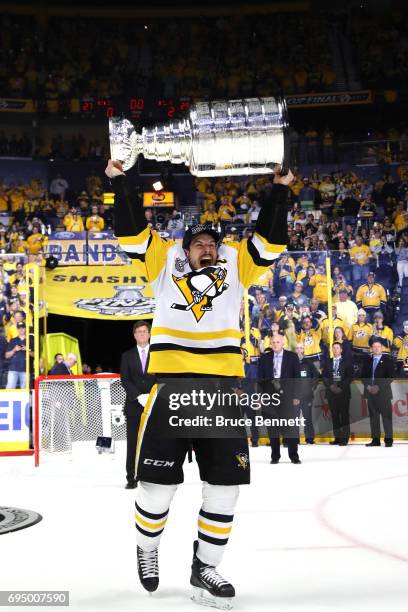 Sidney Crosby of the Pittsburgh Penguins celebrates with the Stanley Cup Trophy after they defeated the Nashville Predators 2-0 to win the 2017 NHL...