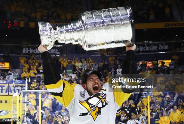 Sidney Crosby of the Pittsburgh Penguins celebrates with the Stanley Cup Trophy after they defeated the Nashville Predators 2-0 to win the 2017 NHL...