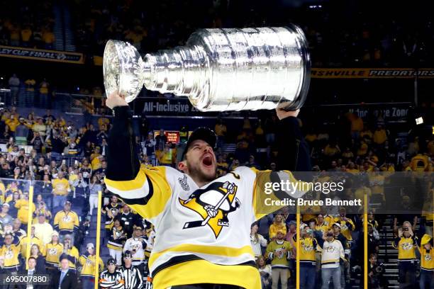 Sidney Crosby of the Pittsburgh Penguins celebrates with the Stanley Cup Trophy after they defeated the Nashville Predators 2-0 to win the 2017 NHL...