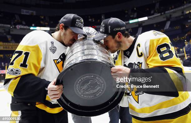 Evgeni Malkin and Sidney Crosby of the Pittsburgh Penguins kiss the Stanley Cup Trophy after defeating the Nashville Predators 2-0 in Game Six to win...