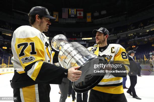 Evgeni Malkin and Sidney Crosby of the Pittsburgh Penguins celebrate with the Stanley Cup Trophy after defeating the Nashville Predators 2-0 in Game...