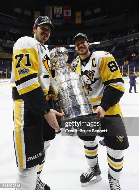 Evgeni Malkin and Sidney Crosby of the Pittsburgh Penguins celebrate with the Stanley Cup Trophy after defeating the Nashville Predators 2-0 in Game...