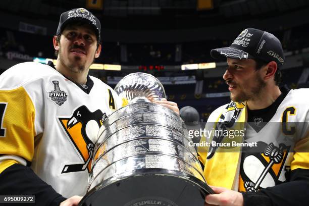 Evgeni Malkin and Sidney Crosby of the Pittsburgh Penguins celebrate with the Stanley Cup Trophy after defeating the Nashville Predators 2-0 in Game...