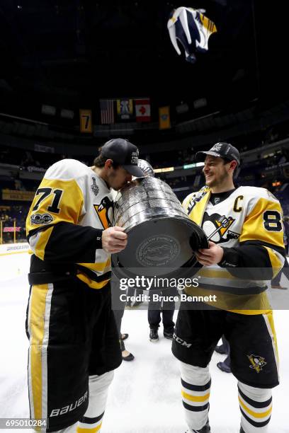 Evgeni Malkin and Sidney Crosby of the Pittsburgh Penguins celebrate with the Stanley Cup Trophy after defeating the Nashville Predators 2-0 in Game...