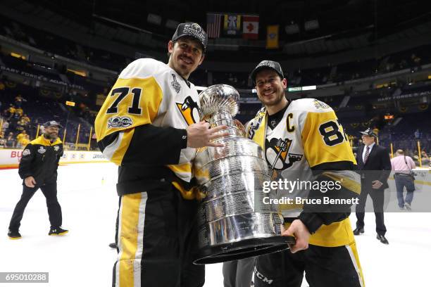 Evgeni Malkin and Sidney Crosby of the Pittsburgh Penguins celebrate with the Stanley Cup Trophy after defeating the Nashville Predators 2-0 in Game...