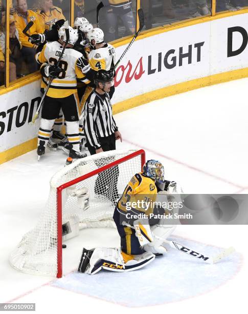 Patric Hornqvist of the Pittsburgh Penguins celebrates with teammates after scoring a goal against Pekka Rinne of the Nashville Predators during the...