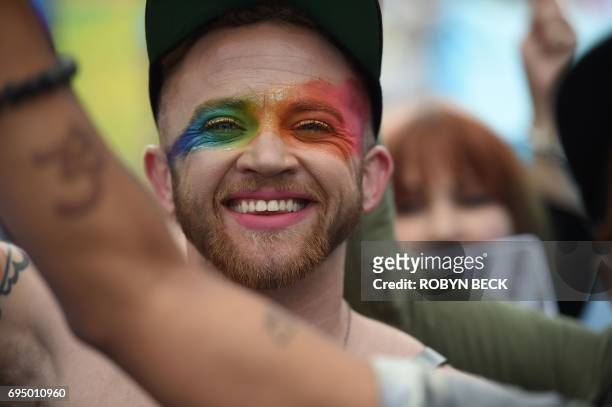 Members of the LGBT community and their supporters participate in the #ResistMarch at the 47th annual LA Pride Festival in Hollywood, California on...