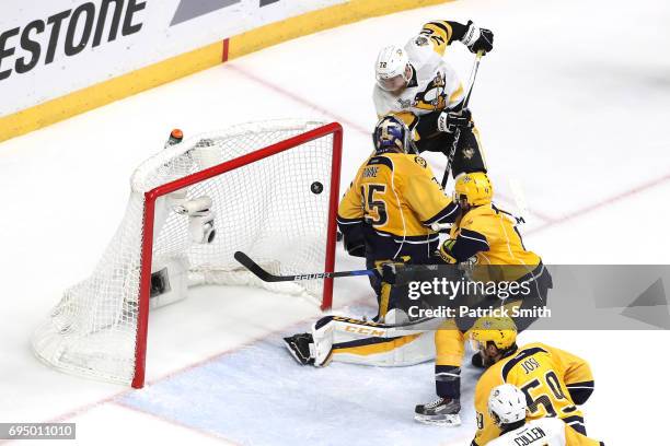 Patric Hornqvist of the Pittsburgh Penguins scores a goal against Pekka Rinne of the Nashville Predators during the third period in Game Six of the...