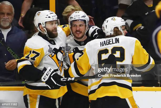 Bryan Rust, Sidney Crosby and Carl Hagelin of the Pittsburgh Penguins celebrate against the Nashville Predators during the third period in Game Six...