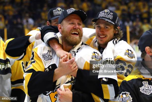 Patric Hornqvist of the Pittsburgh Penguins celebrates with Carl Hagelin after defeating the Nashville Predators 2-0 in Game Six of the 2017 NHL...