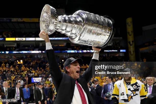 Head coach Mike Sullivan of the Pittsburgh Penguins celebrates with the Stanley Cup Trophy after defeating the Nashville Predators 2-0 in Game Six of...