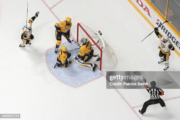 Patric Hornqvist of the Pittsburgh Penguins celebrates after scoring the game-winning goal past goalie Pekka Rinne of the Nashville Predators in the...