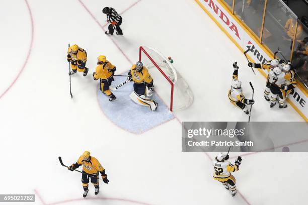 Patric Hornqvist of the Pittsburgh Penguins celebrates after scoring the game-winning goal past goalie Pekka Rinne of the Nashville Predators in the...