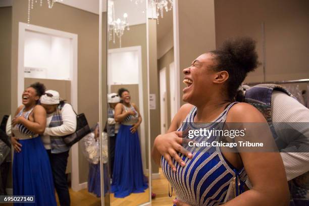 Sonitra Mitchell laughs as her boyfriend's mother, Lynn Evans, jokes about fitting into a dress during prom dress shopping May 19 at Chicago Ridge...