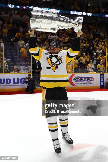 Ron Hainsey of the Pittsburgh Penguins celebrates with the Stanley Cup trophy after defeating the Nashville Predators 2-0 in Game Six of the 2017 NHL...