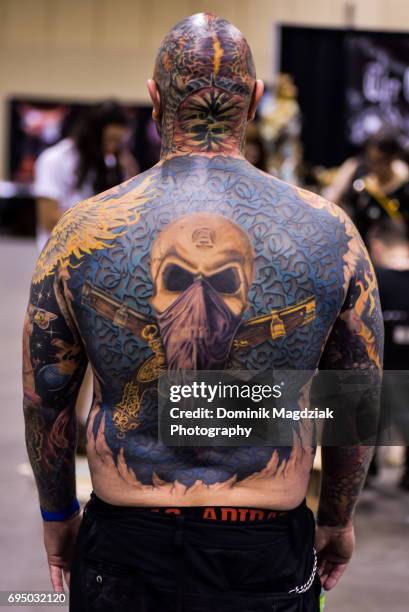 Participant enters the tattoo contest for best back piece during day three of the "19th Annual Northern Ink Xposure Tattoo Convention" at the Metro...