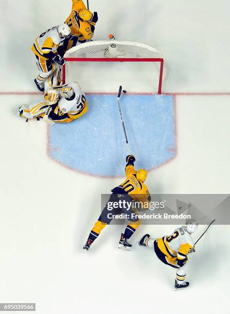 Matt Murray of the Pittsburgh Penguins defends the goal as Colton Sissons of the Nashville Predators reachs for the puck during the second period in...