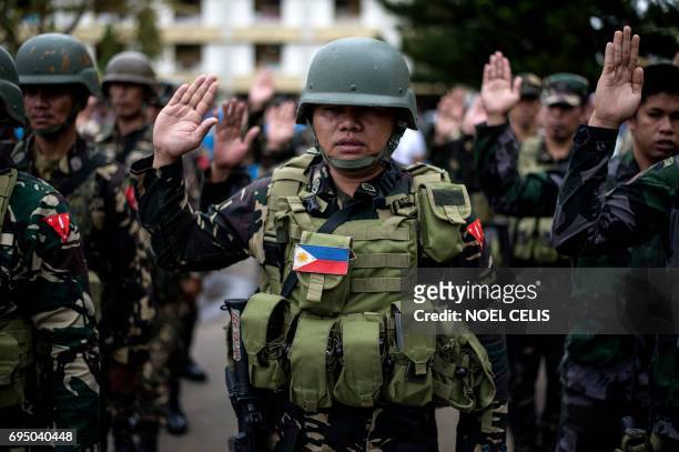 Soldier takes an oath during a flag raising ceremony at the Lanao Del Sur provincial capital of Marawi on the southern island of Mindanao on June 12,...