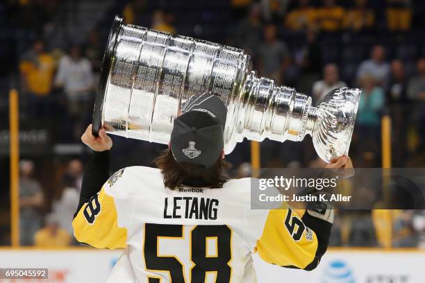 Kris Letang of the Pittsburgh Penguins celebrates with the Stanley Cup trophy after defeating the Nashville Predators 2-0 in Game Six of the 2017 NHL...