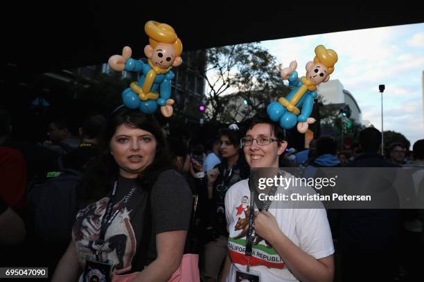 Game enthusiasts wearing 'Vault Boy' balloon hats mingle during the Bethesda E3 conference at the LA Center Studios on June 11, 2017 in Los Angeles,...