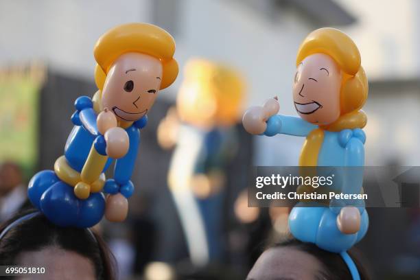 Game enthusiasts wearing 'Vault Boy' balloon hats mingle during the Bethesda E3 conference at the LA Center Studios on June 11, 2017 in Los Angeles,...