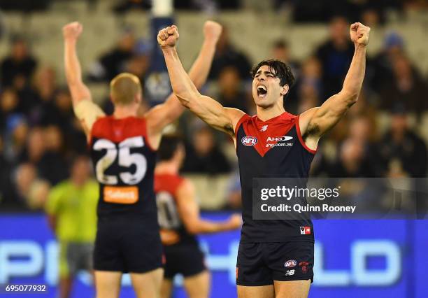 Tom McDonald and Christian Petracca of the Demons celebrate winning the round 12 AFL match between the Melbourne Demons and the Collingwood Magpies...