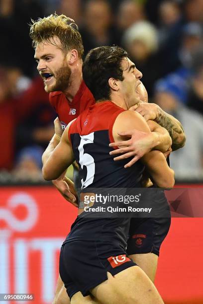 Jack Watts of the Demons is congratulated by Christian Petracca after kicking a goal during the round 12 AFL match between the Melbourne Demons and...