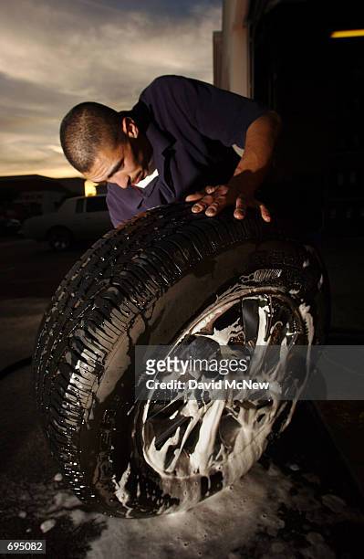 Rent-A-Wheel employee Jose Curiel washes rental rims, January 25 in Santa Ana, CA. Despite the recent economic downturn, custom wheel consumers...