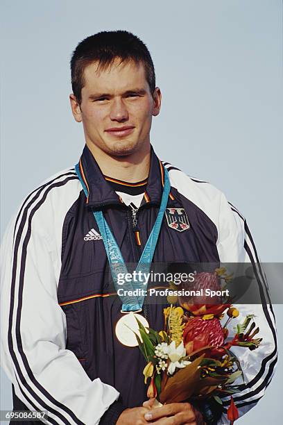 German slalom canoeist Thomas Schmidt poses with his gold medal on the podium after finishing in first place in the Men's slalom K-1 kayak canoe...