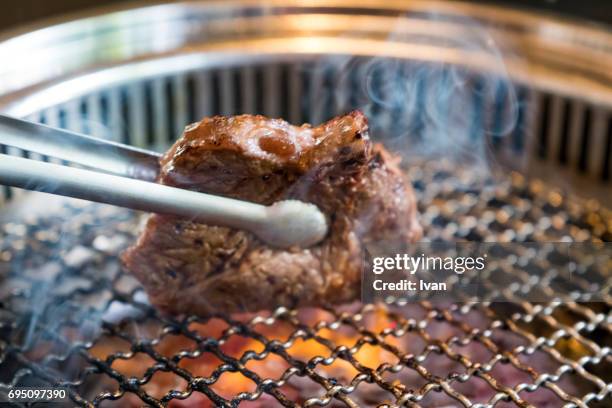 grilled steak with flame, japanese yakiniku - smoking meat stock pictures, royalty-free photos & images