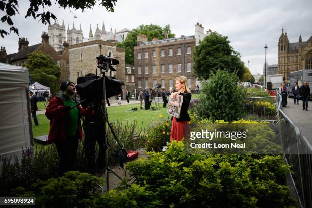 An international news reporter holds a copy of The Sun newspaper as she talks about the election on June 12, 2017 in London, England. Labour leader...
