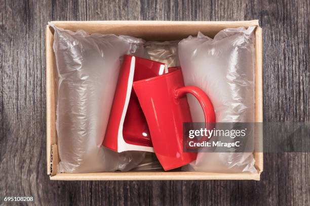 damaged cup in parcel - strikeforce stock pictures, royalty-free photos & images