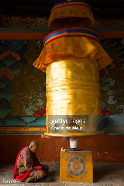 golden prayer wheel - bhutan monk stock pictures, royalty-free photos & images