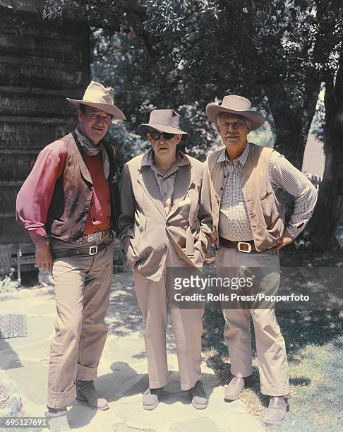From left, American actor John Wayne , American film director John Ford and fellow American actor Ward Bond pictured together on the set of a Western...